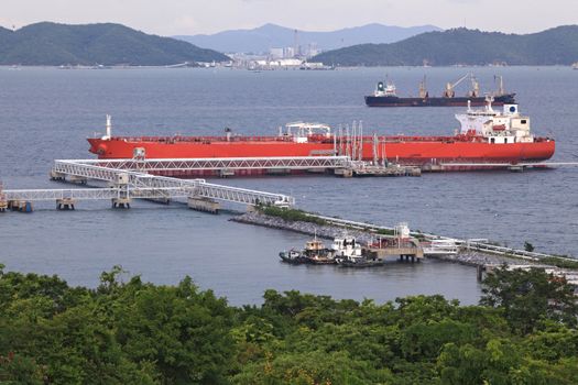 aerail view of Big red boat unloading cargo at dock pier