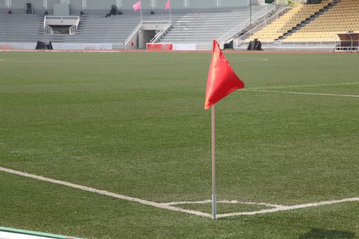 soccer corner flag in a large stadium filled 