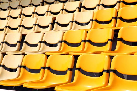 old and new yellow seat in stadium