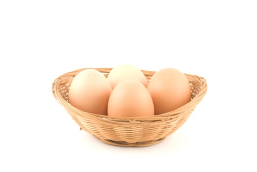 eggs in a wicker basket on white background