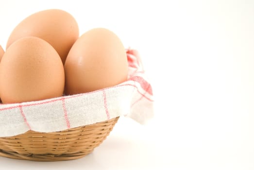 eggs in a wicker basket on white background