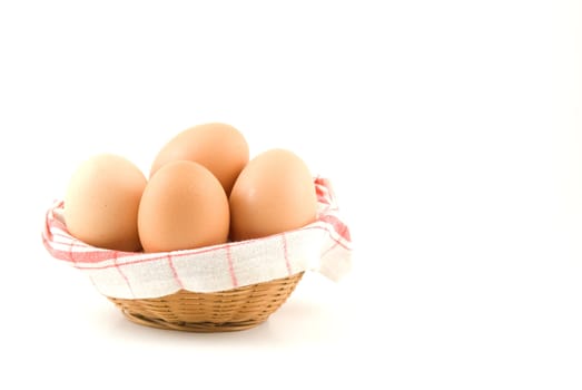 eggs in a wicker basket on white background