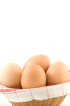 eggs in a wicker basket on white background