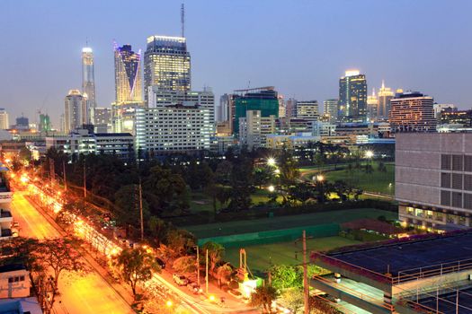 Bangkok cityscape skyscraper with light trail of freeway to the city