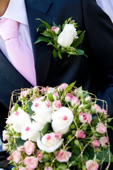 unusual bouquet in hands of the groom