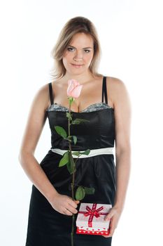 portrait of a young and beautiful girl with a gift and a rose
