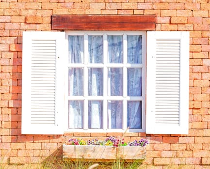 Vintage white window on red brick wall