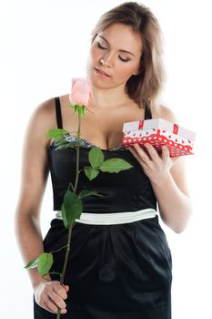 portrait of a young and beautiful girl with a gift and a rose