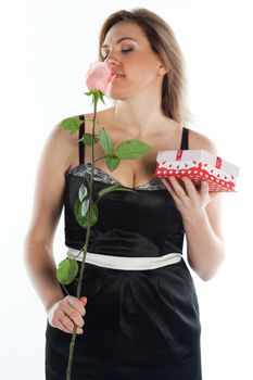 portrait of a young and beautiful girl with a gift and a rose