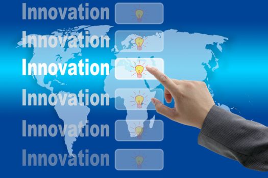 male business hand pushing on Innovation button with world map background