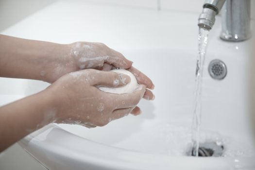 Human washing hands with soap. Close-up photo