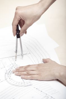 Hands of engineer working on a construction plan