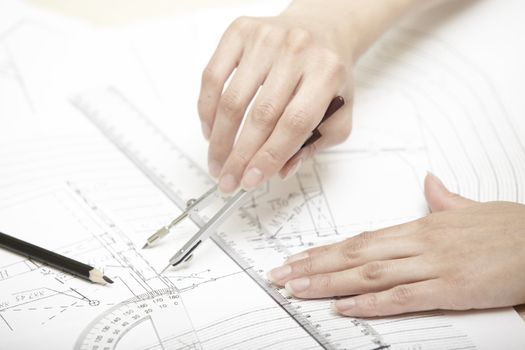Hands of engineer working on a construction plan