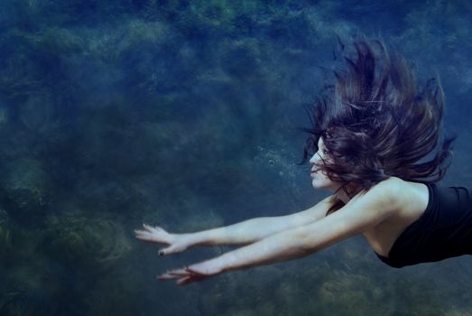 Beautiful lady swimming and diving underwater