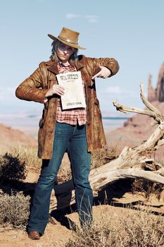 very bad cowgirl with wanted paper at Monument Valley