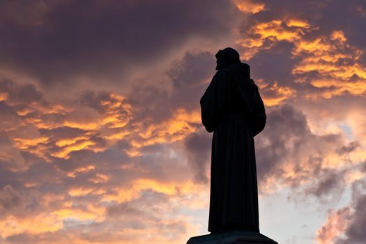 Monk Silhuete and Dusky Cloudy Sky