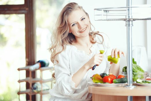 Blond lady at kitchen preparing vegetable for breakfast