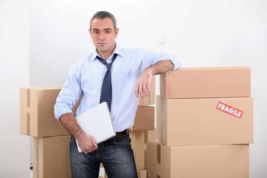 Man stood by stacked boxes