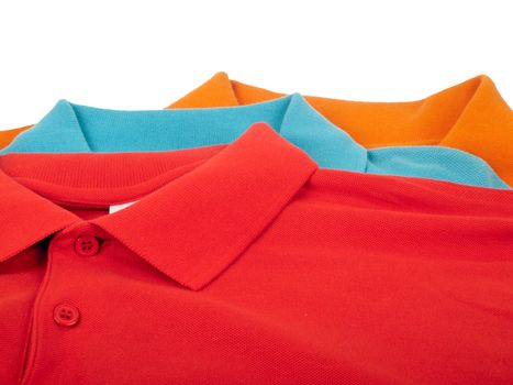 pile of man polo shirts isolated on white background