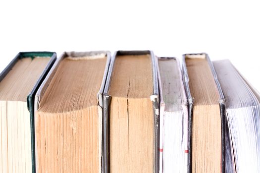 Pile of Old Antique Books on white background (focus on top of books)