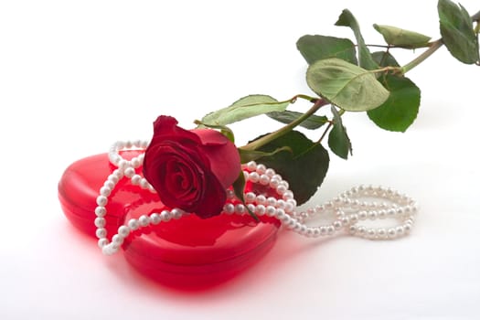 Valentine Roses and a red box with a beads on a white background