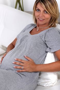a pregnant woman touching her stomach