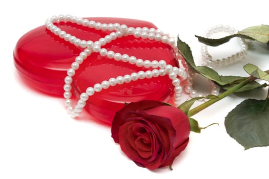 Valentine Roses and a red box with a beads on a white background