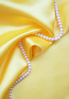 Smooth elegant golden silk with pearls can use as background