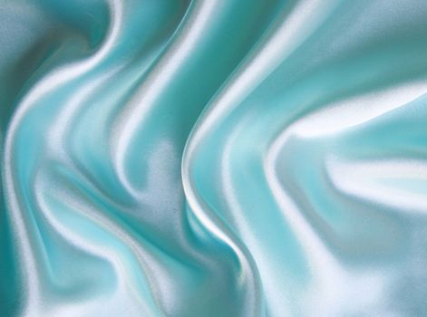 Smooth elegant blue silk as background 