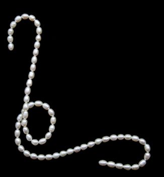 White pearls on the black velvet background 