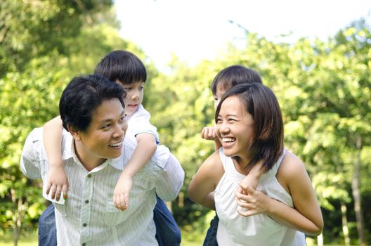 Happy Asian family having fun in a nice summer day.
