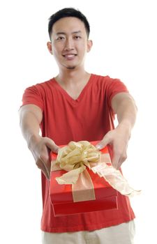 Asian young man giving a gift box on white background