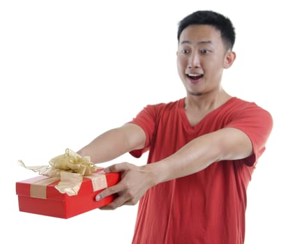 Asian young man giving a gift box on white background