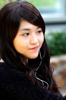 Asian woman listening music