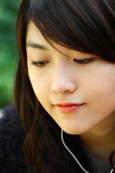 Asian woman listening music