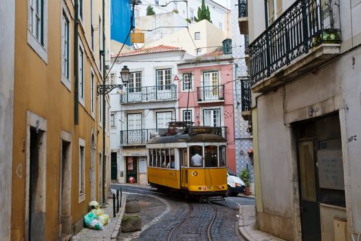 Classic Yellow Tram in Alfama quater in Lisbon, Portugal