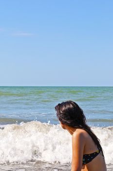 Girl on a deserted beach in a bay in Ecuador