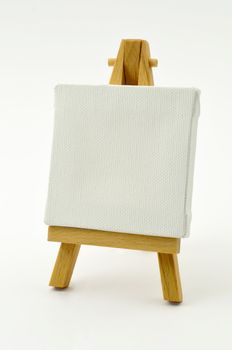 Little wood easel and white canvas