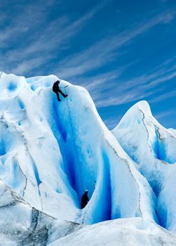 Two men climbing a glacier in patagonia.