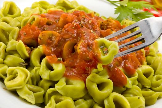 Plate of italian tortellini with tomato sauce.