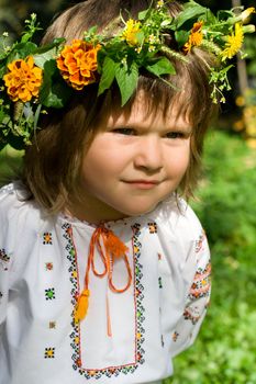 Pretty little girl dressed in Ukrainian folk costume with focused look