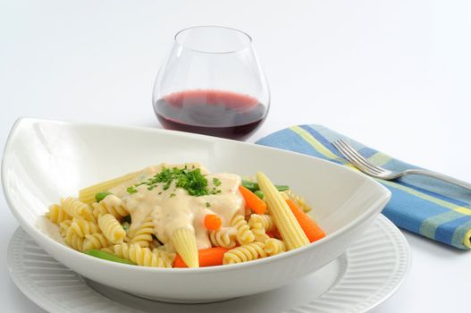 Delicious pasta with fresh vegetables and four cheese sauce.