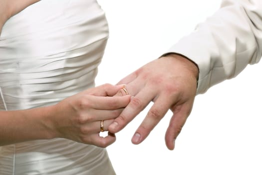 The bride dresses a ring on a finger of the groom