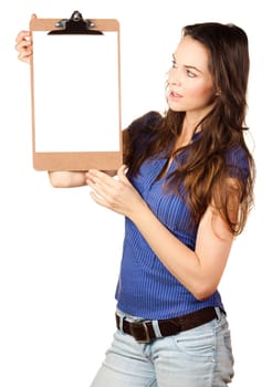 Beautiful young woman holding and looking up at blank clipboard