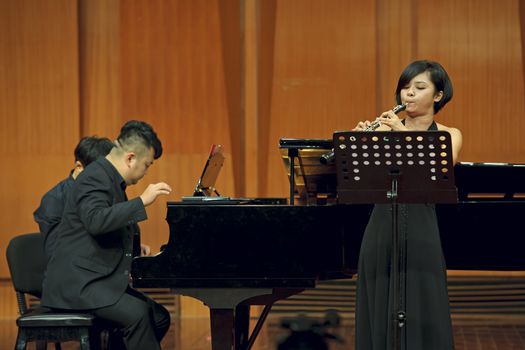 CHENGDU - JUN 20: oboist performs on wind music chamber music concert at odeum of Sichuan Conservatory of Music on Jun 20,2012 in Chengdu,China.