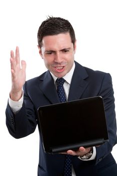 Portrait of frustrated and angry young business man in blue suit with laptop. Isolated on white.