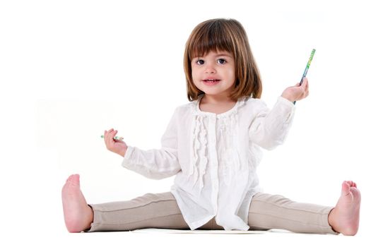 Portrait of cute little girl holding pencils. Isolated on white background.