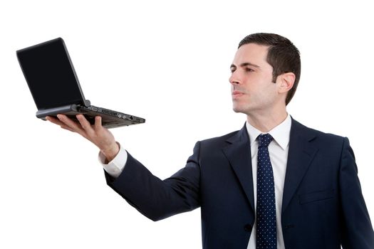 Handsome young business man in blue suit holding  laptop up high. Isolated on white.