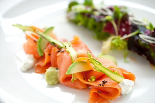 Close up of smoked salmon salad with green asparagus and avocado
