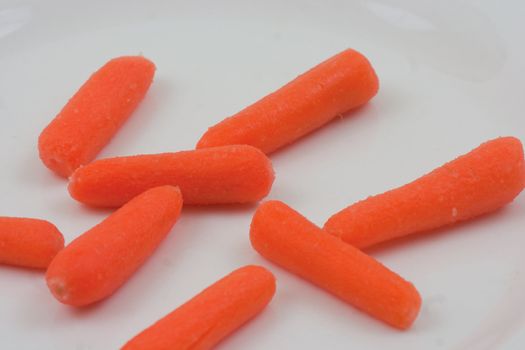Baby carrotts laid out  on a white background